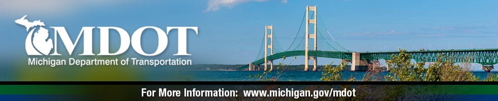 The Mackinac Bridge on a sunny day with blue skies and trees in the forefront with the MDOT logo and the MDOT webpage address.